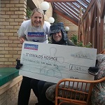 Dominic Bezzina and his cheque to St Oswalds Hospice