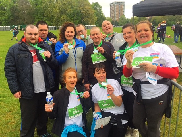 Staff and people supported at Gordon House and St Michaels proudly pose with their medals