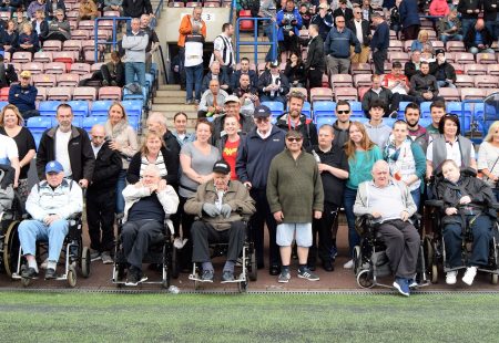 People Supported by Community Integrated Care have their photo taken with Vikings players Alex Gerrard and Joe Mellor