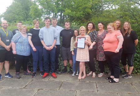 Students from Hugh Baird College present St Michaels with a commemorative plaque after completing their Prince's Trust garden project