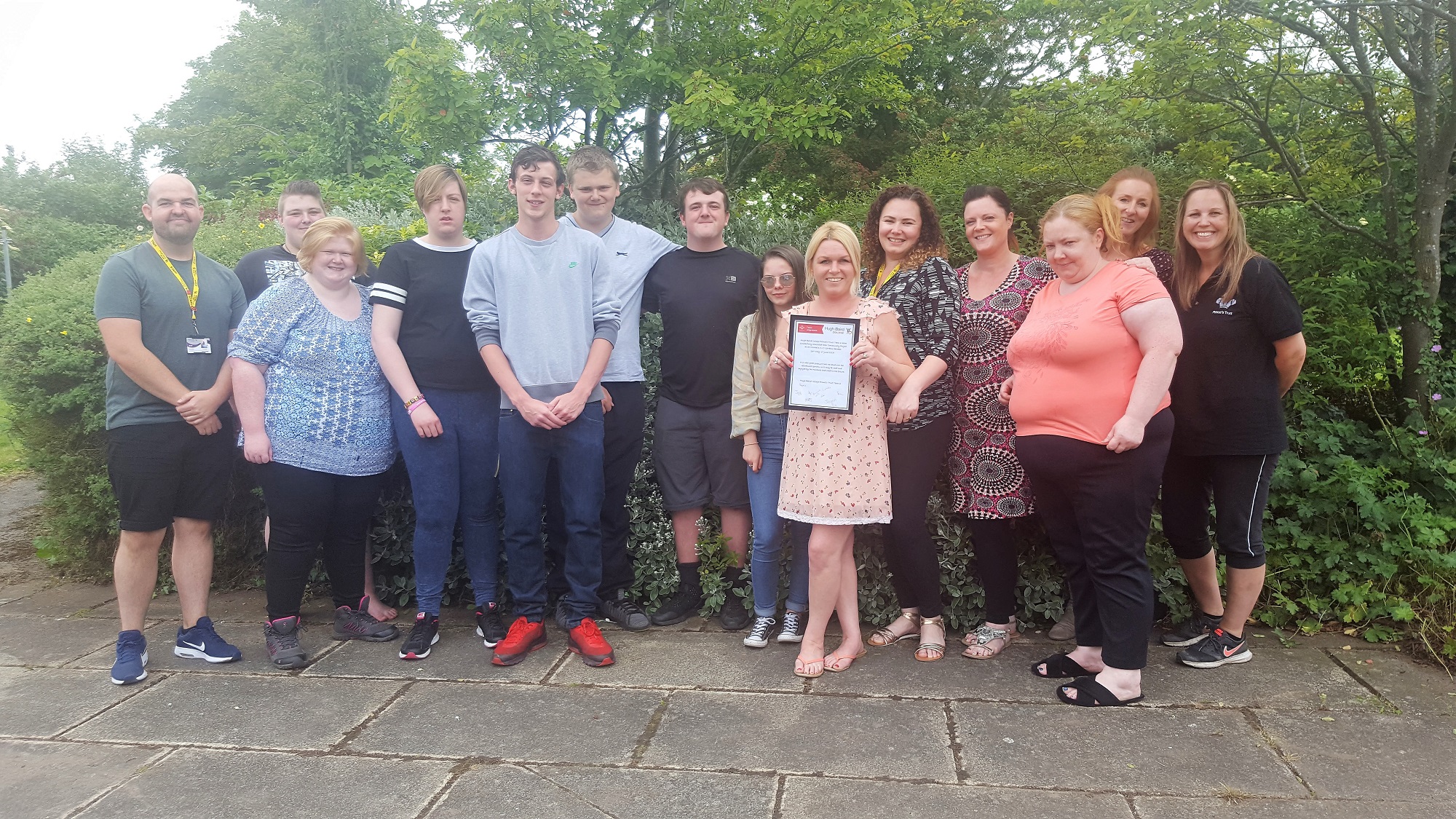 Students from Hugh Baird College present St Michaels with a commemorative plaque after completing their Prince's Trust garden project