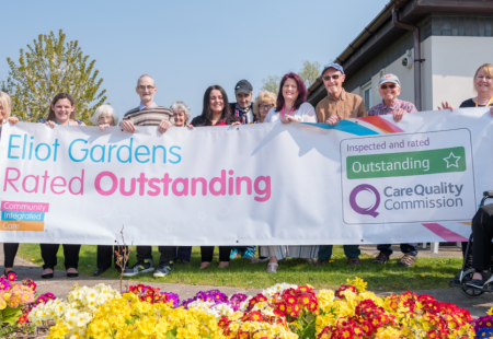 Community holding sign for outstanding