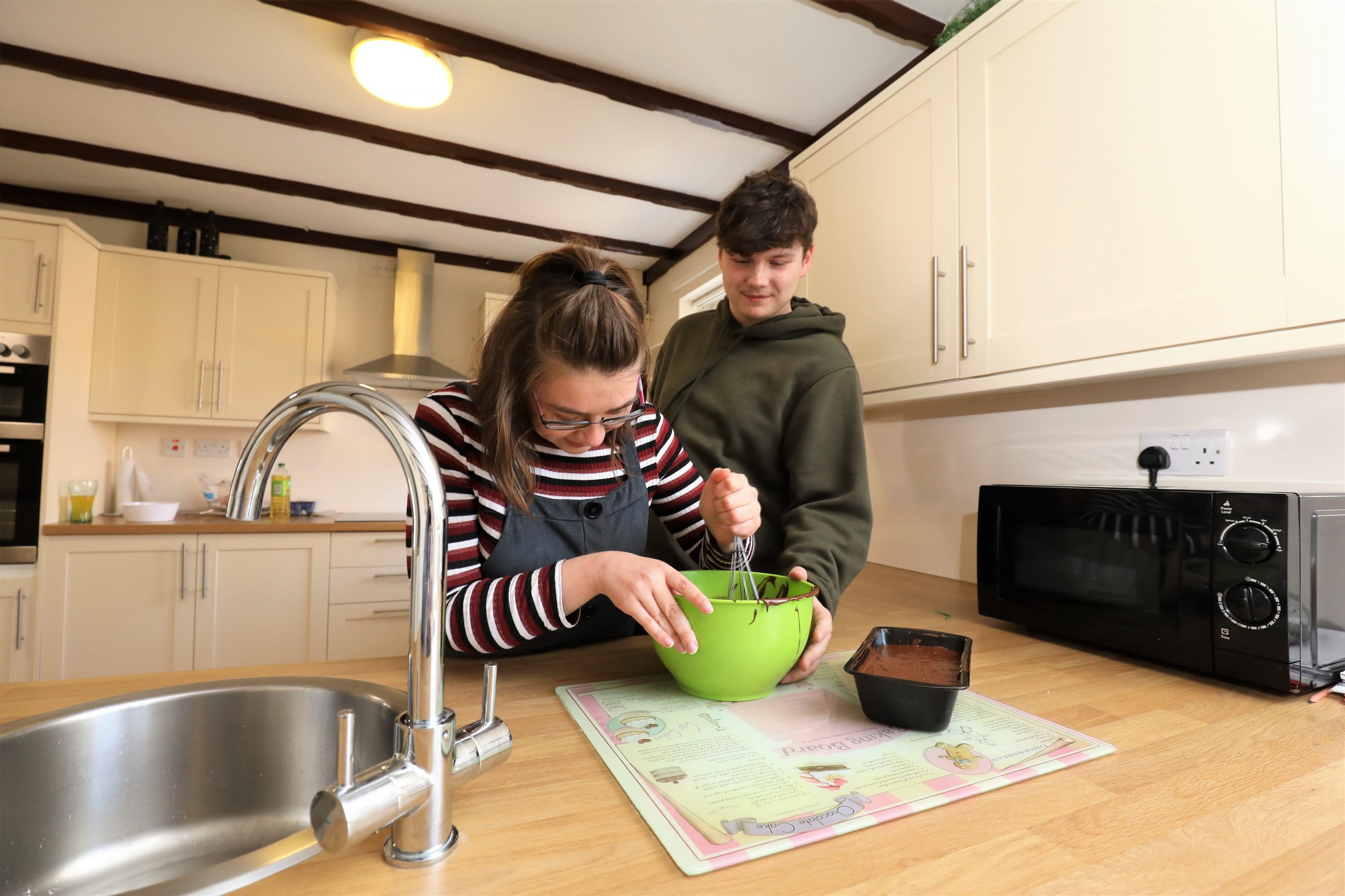 Man and woman baking a cake