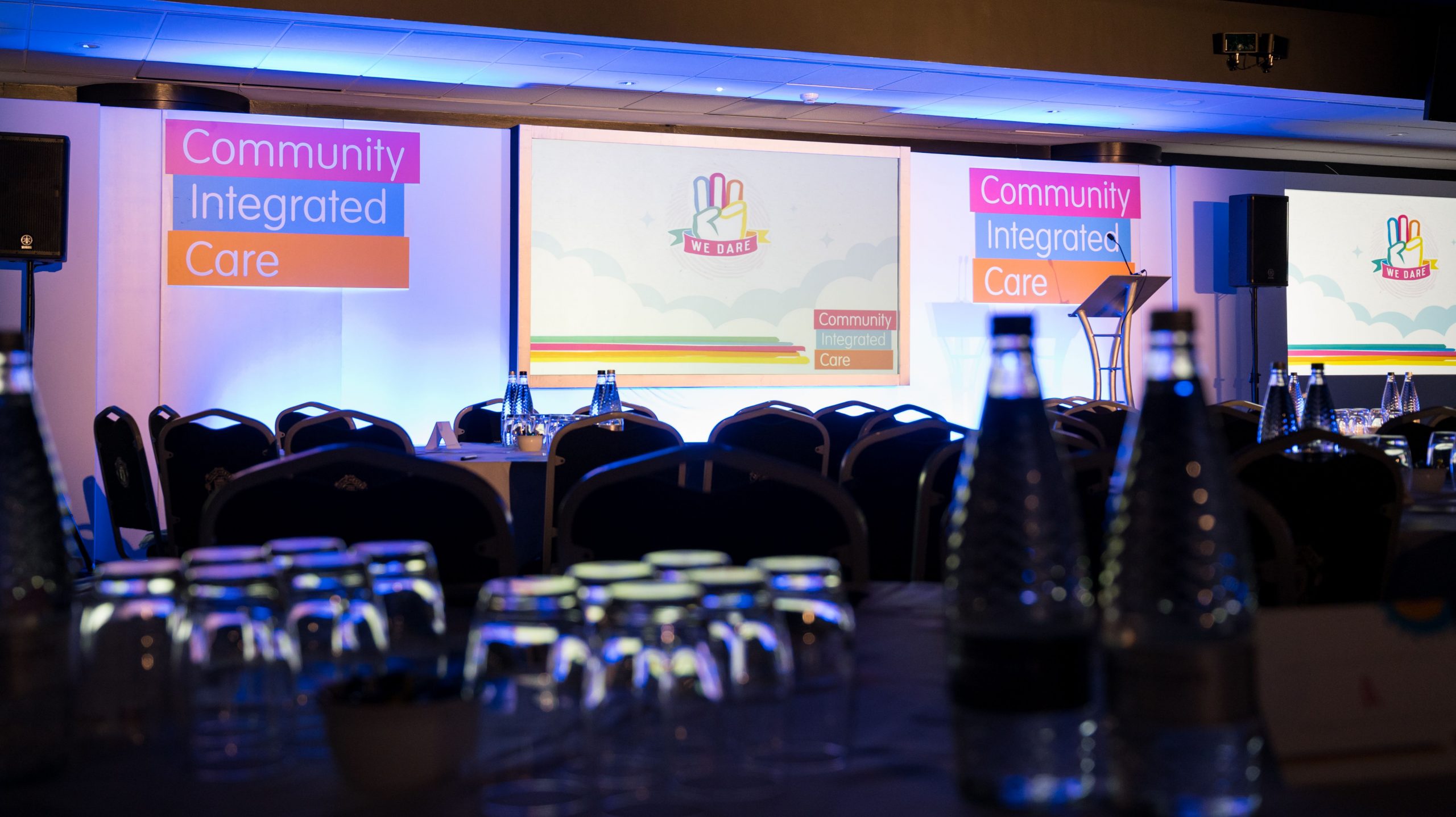Background image of stage at Community Integrated Care roadshow