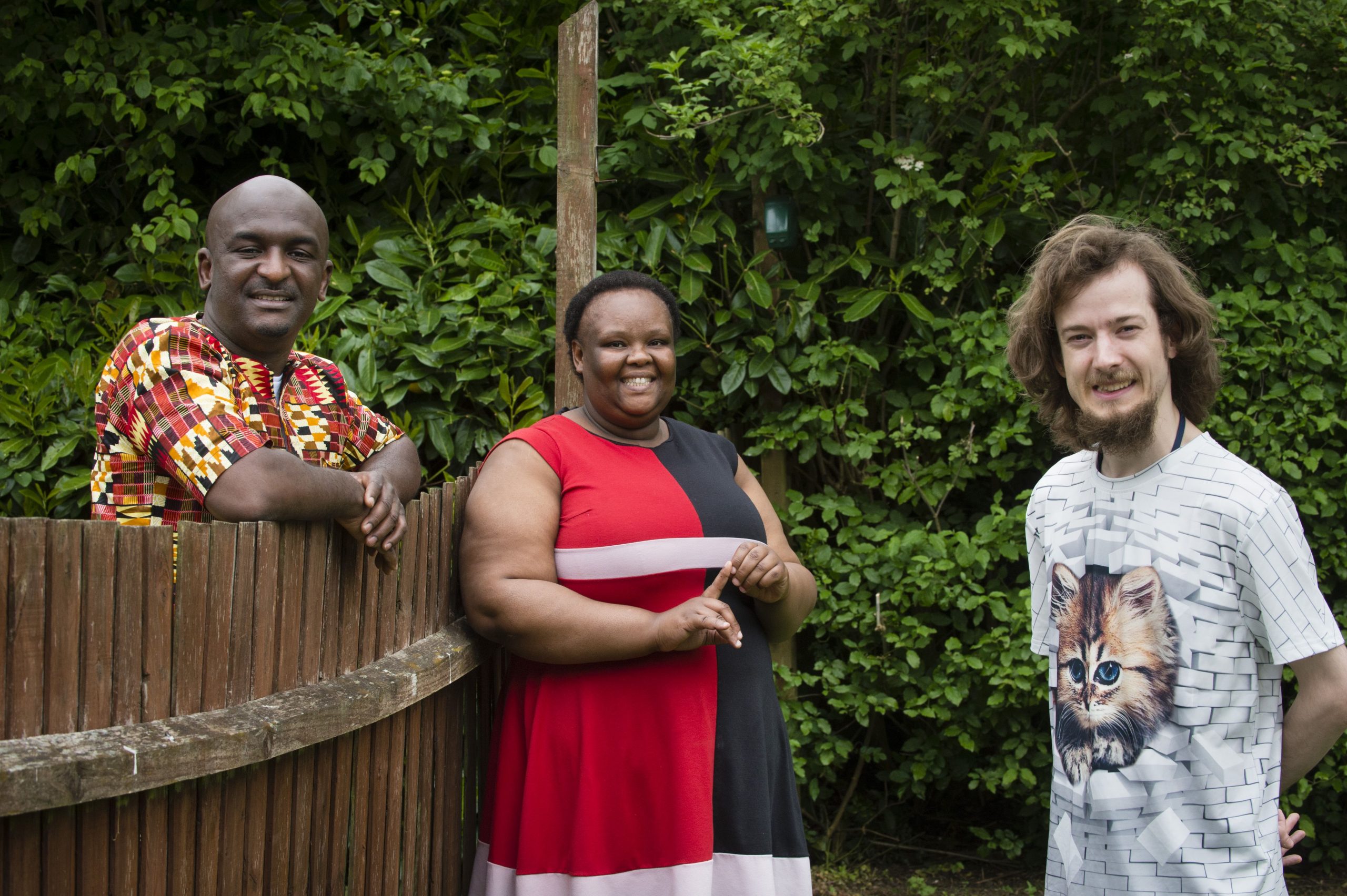 Colleagues smiling over fence