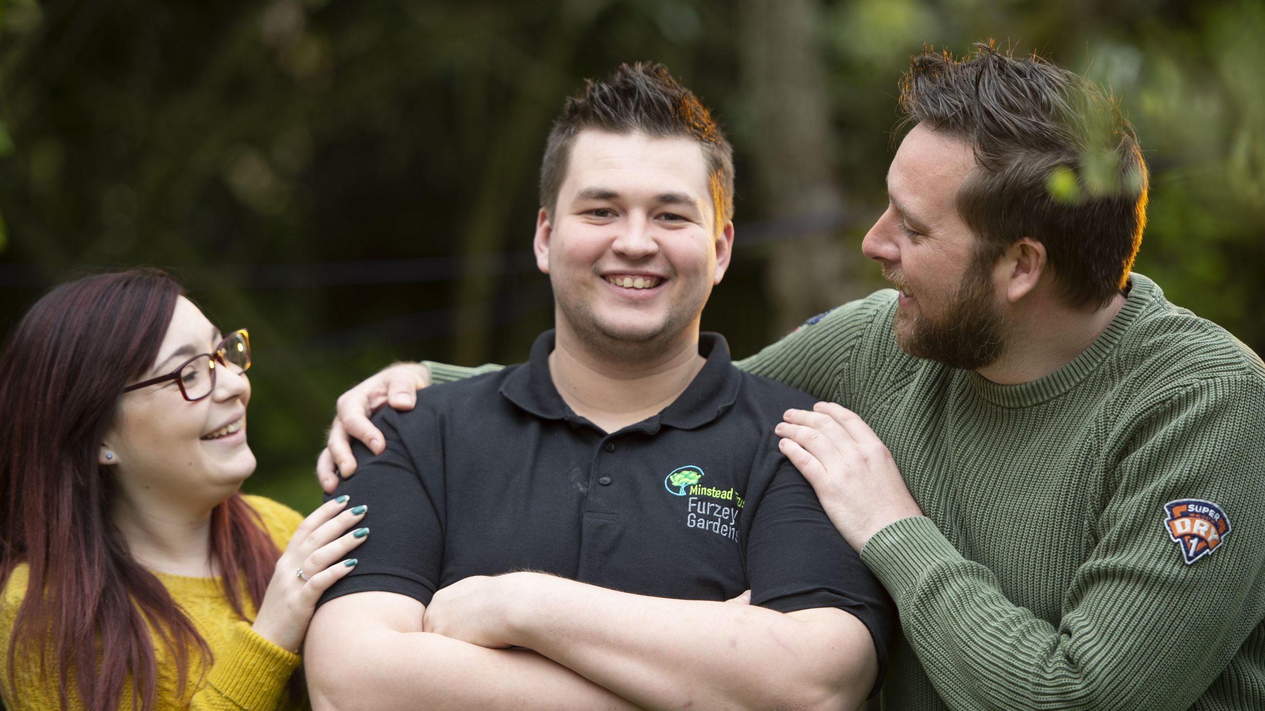 Two people congratulating man