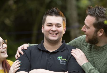 Two people congratulating man