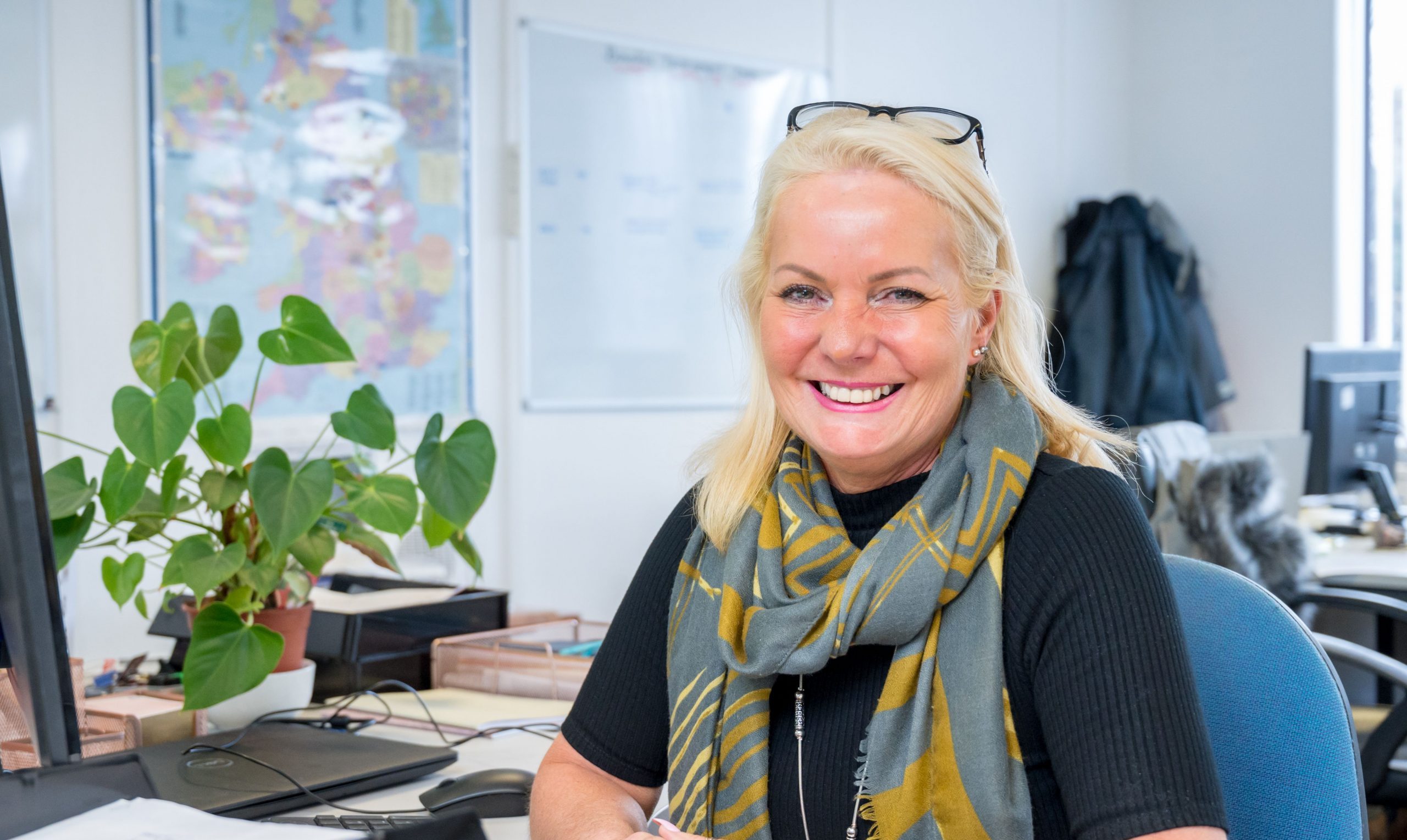 Colleague sat at desk smiling
