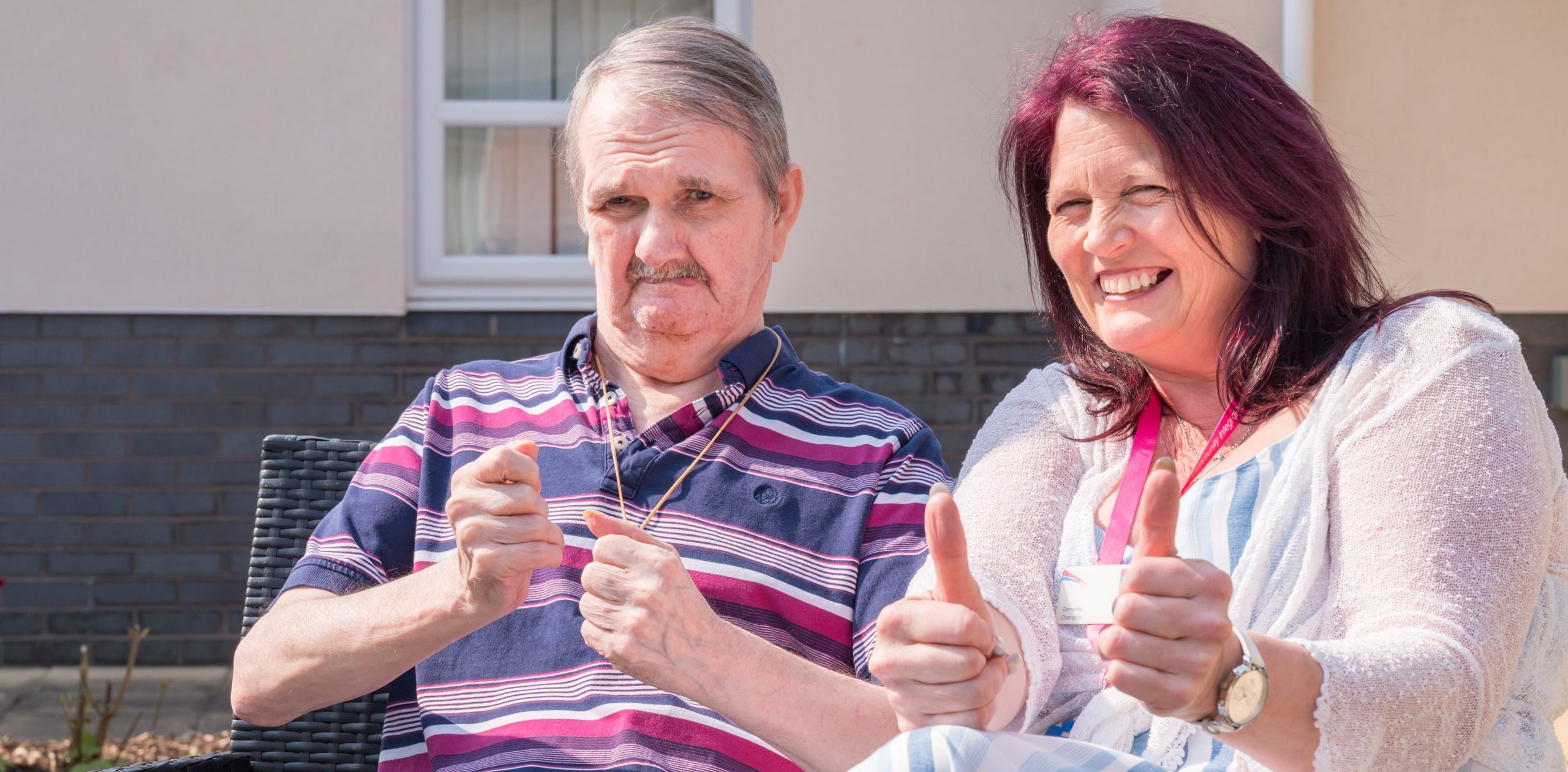 Colleague and person supported smiling with thumbs up. North west. Eliot gardens.