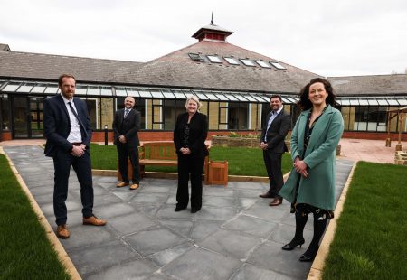 People standing in front of Kirkdale house