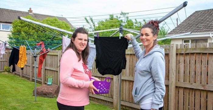 Person we support putting clothes on washing line