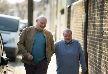 South - colleague and person supported walking down street
