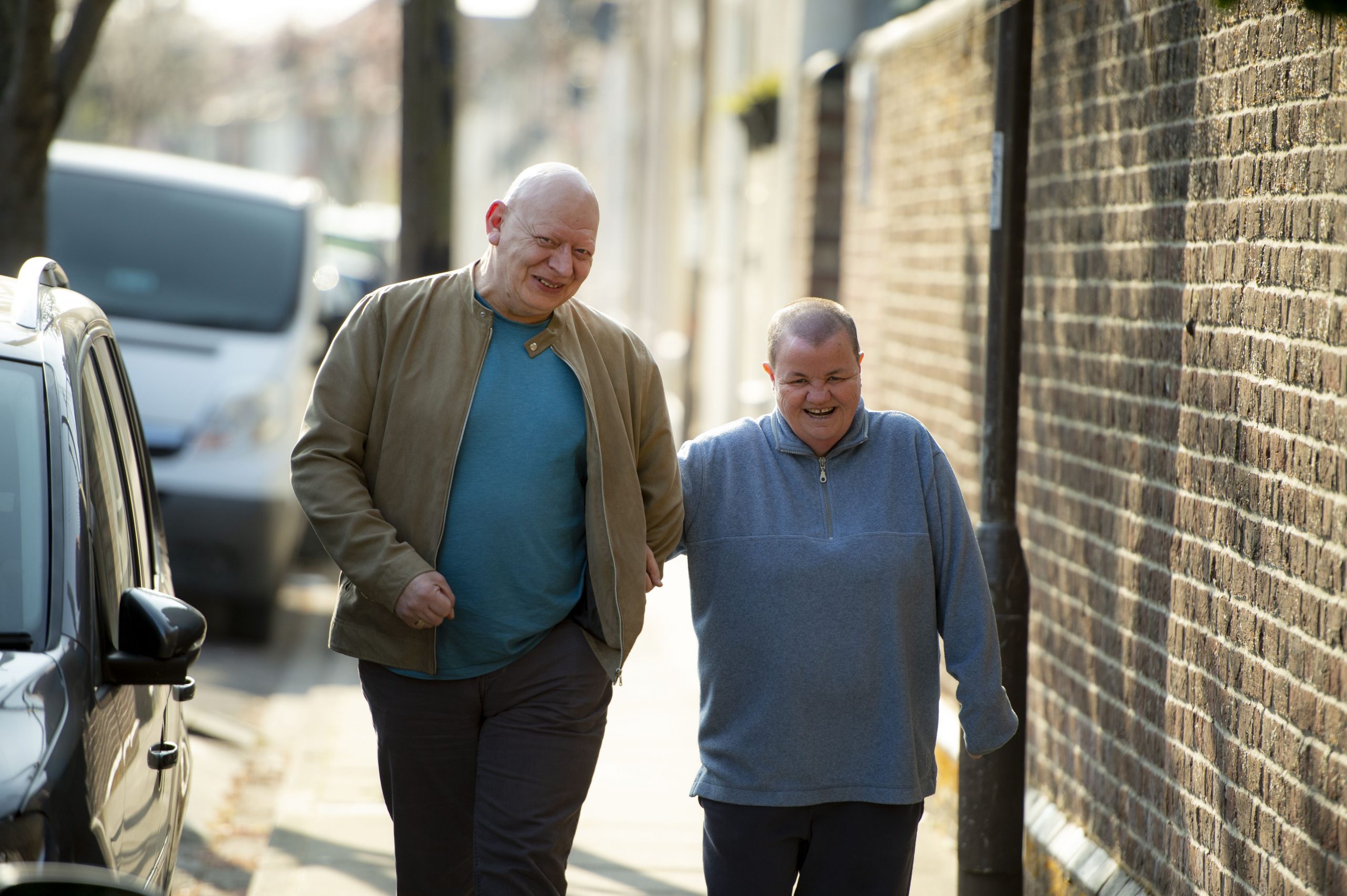 South - colleague and person supported walking down street