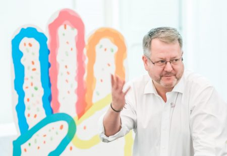 Mark adams at a roadshow introducing We Dare