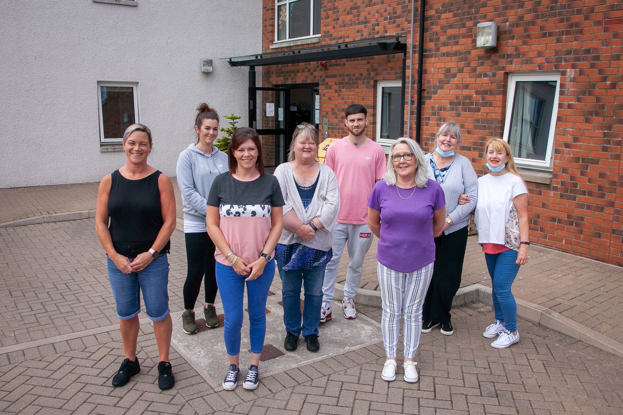 Group of colleagues from school close in Scotland stood socially distanced