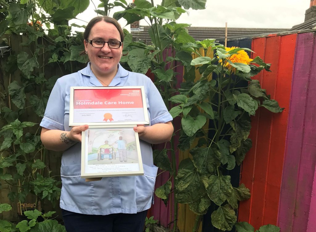 Jenny Wallace, a Support Worker at our Holmdale service in Runcorn with Arts award and artwork.