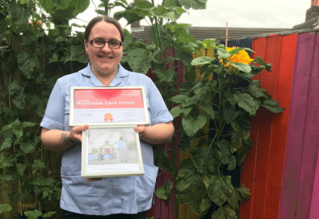 Jenny Wallace, a Support Worker at our Holmdale service in Runcorn with Arts award and artwork.