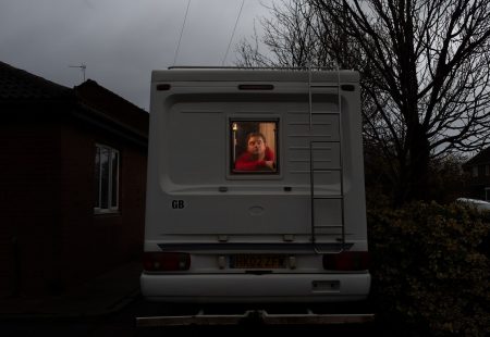 Support Worker, Neil, looking out a motorhome where he self-isolated to protect his family.