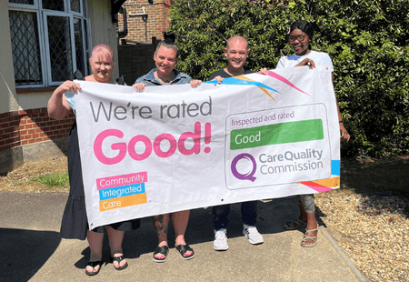 Mullion team hold CQC banner reading We're rated Good!!