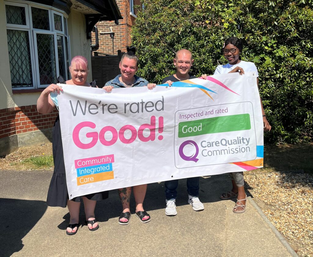 The Mullion team holding a Good CQC Banner