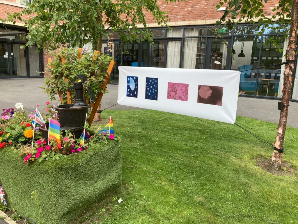 Photography hung up in the garden at the Watch Factory.