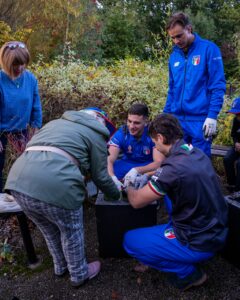 Italy Rugby League team members chat with inclusive volunteers