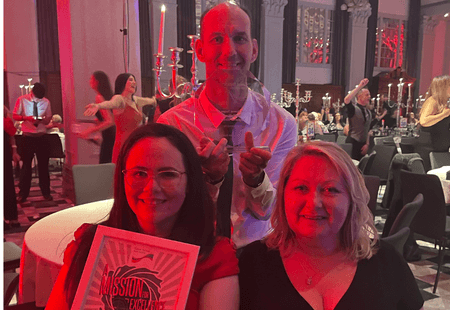 The team from Holmdale smile holding their Award for Care Team in North West.