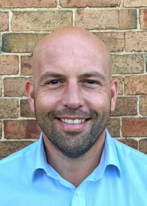 Edd Terry profile picture. Smiling at camera wearing a blue shirt.