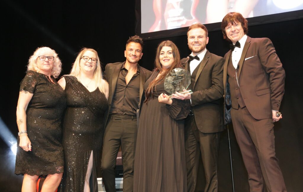 The team at Kirkdale House stood with Peter Andre and the GB Care Awards host, collecting their award for Housing with Care champions.