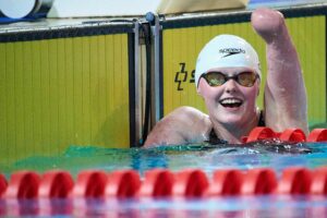 Para swimmer Ellie Challis celebrating a race in the swimming pool