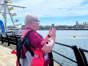 Inclusive Volunteer photographing Tall Ship event