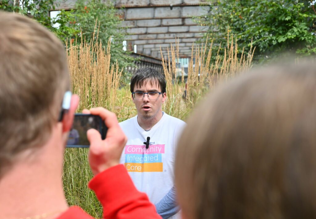 Volunteer, Jake, films outside for Young Voices