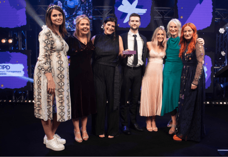 Members of Community Integrated Care's learning and development team onstage collecting their winning CIPD Award.