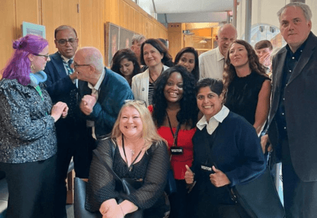 Colleagues from COmmunity Integrated Care stand with a group of colleagues from across the Care Sector in the House of Commons