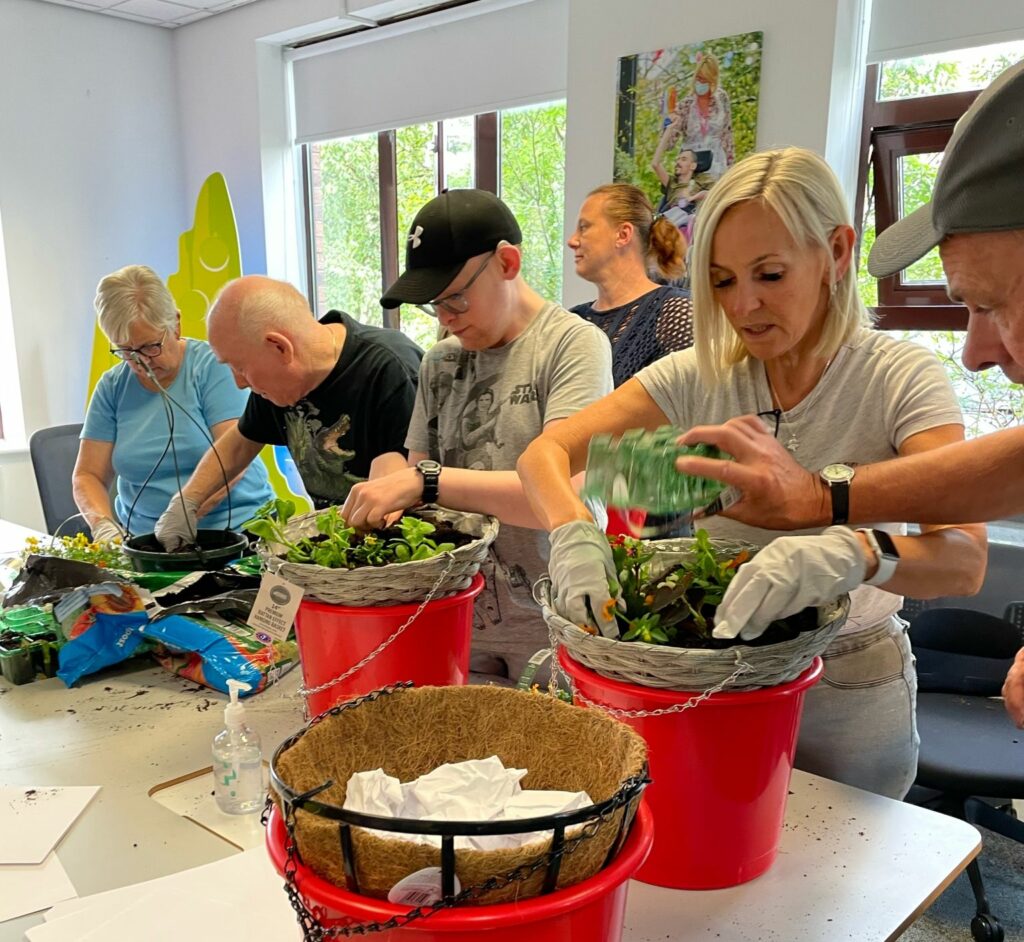 Colleagues and people supported by community Integrated Care taking part in a planting workshop, thanks to funding from ACS.