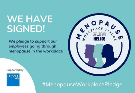 Turquoise badge reading "We have signed the Menopause Workplace Pledge!"