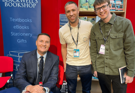 Two colleagues stood posing for a picture with MP