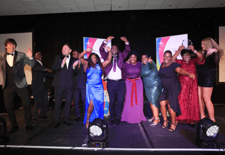 The Gilmorton team dance and cheer onstage at the Great East Midlands Care Awards.