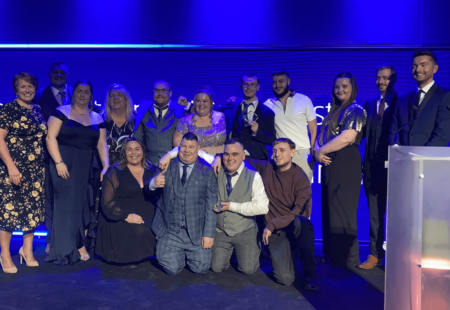 Two of our Scottish teams, lined up on stage at the Scottish Social Services Awards, to collect their awards.