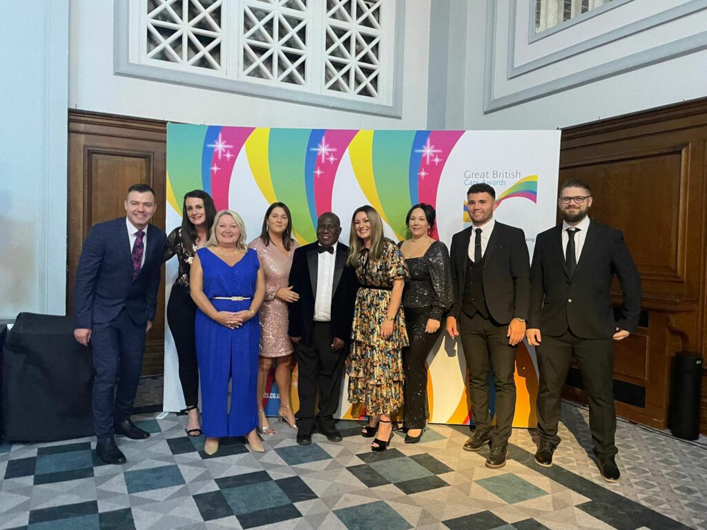 A group of colleagues dressed in formal wear pose for a photo at the North West Care Awards.