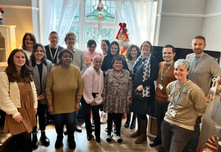 Colleagues and people we support in Leeds, at our Jackson Avenue Supported Living Service, smile for a group picture with representatives from the department of health and social care and NCF.
