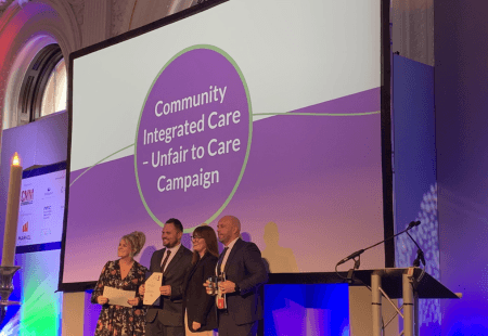 Managing Director, Edd Terrey, and Head of Operations, James Brind, on stage at the Markel 3rd Sector Care Awards, collecting the Campaigning for Change trophy for Unfair to Care.