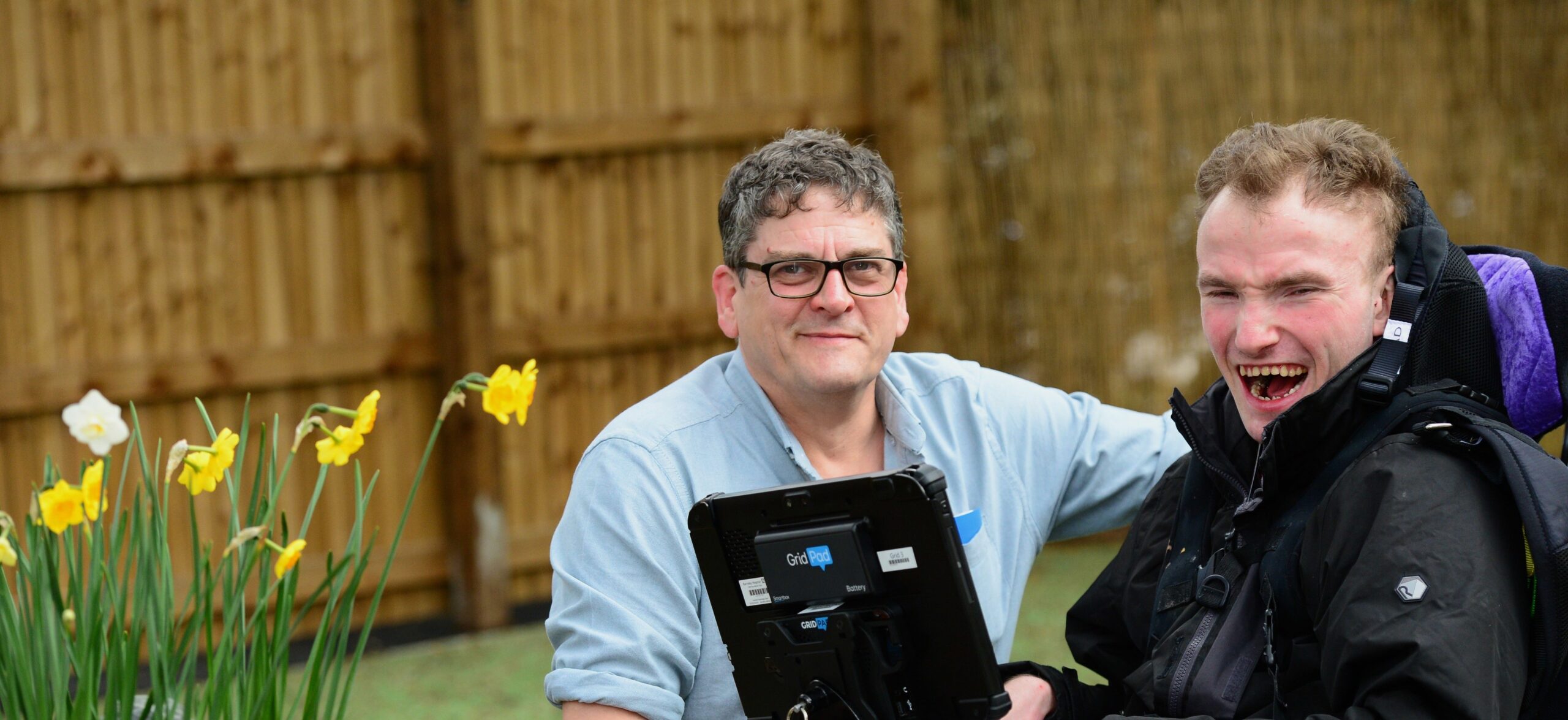 Person supported in motorised wheelchair.