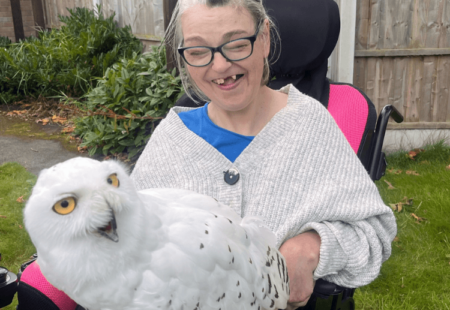 Tracy with a big smile on her face, whilst holding the snowy owl.