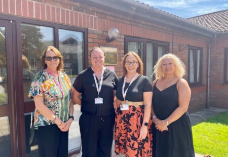 Staff standing with local MP Kim Johnson