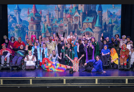 The full cast of the Cinderella in Chaos Pantomime onstage cheering, at the Aberdeen Arts Centre.