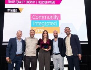 Colleagues on stage collecting our trophy at the 2025 Sports Business Awards