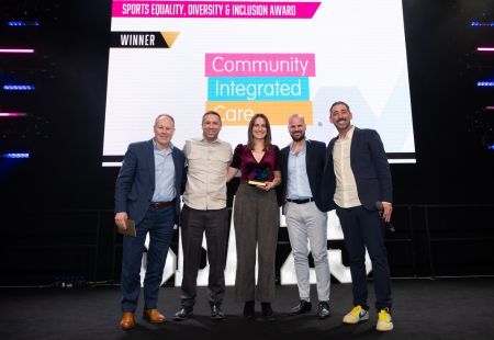 Colleagues on stage collecting our trophy at the 2025 Sports Business Awards
