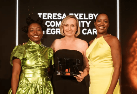 Our Chief Corporate Services and People Officer, Teresa Exelby, stands onstage with the trophy at the HR Excellence Awards.