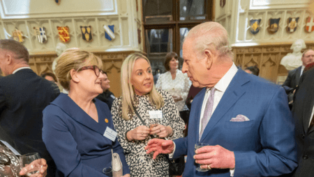 Amandajayne speaking to the King in a stately room at Windsor Castle, for the Royal Reception for social care.